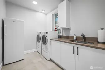 Spacious laundry room with sink and tons of storage. Freezer does not convey.