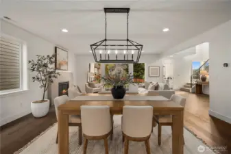 Dining to Great Room View: Thoughtfully designed open-concept plan unites dining and living areas with stylish finishes and abundant light. This inviting flow allows for both intimate dinners and lively gatherings with ease.    Photos are from a previous Glacier model home at Foxmoore and are for visualization purposes only - colors, selections, and included feature can and will vary.