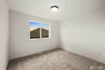 Additional Upper Level Bedroom: Light-filled secondary bedroom with plush carpet and a clean, neutral palette. Flexible in size and design, it’s well-suited for a variety of uses, from restful retreat to creative workspace.    Photos are from a previous Glacier model home at Foxmoore and are for visualization purposes only - colors, selections, and included feature can and will vary.