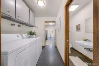 New washer and dryer in laundry room located between garage and kitchen