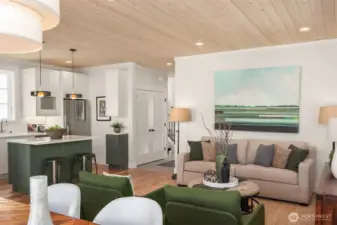 The living room overlooks the custom kitchen.  Painted cabinetry is topped with white quartz countertops and fitted with custom professional grade appliances.