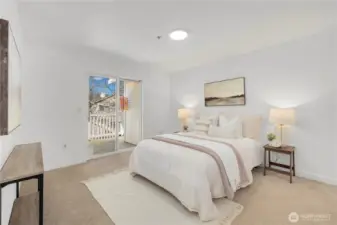 Peaceful primary suite with slider out to patio