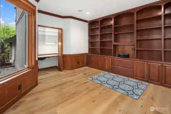 Main floor office with built-in cabinets & new wide plank floors.