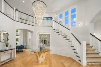 Breathtaking two-story entryway foyer features NEW elegant chandeliers & wide-plank hardwood floors.