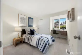 Secondary bedroom with built-in desk area.