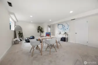 Portion of the family room set up as a game area and workout space.