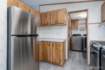 The kitchen offers updated fridge with additional counter space and storage
