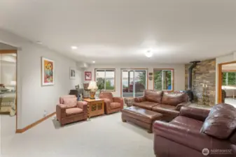 Lower level Den with access to lower deck featuring a wood fired stove and a great view.