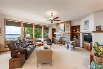 The beautiful stone fireplace with built-in custom made shelving and cabinets and a nice touch of warmth. The custom trim work is consistent throughout the home.
