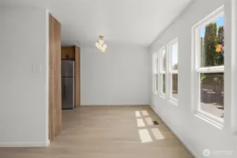 Dining area (around the corner from living area) with kitchen to the left