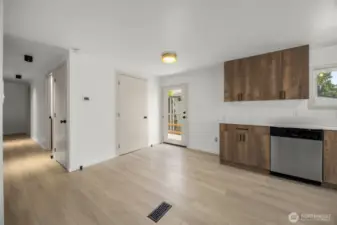 North end of kitchen. Glass door leads out to the back deck. Closed door adjacent to glass door is laundry closet