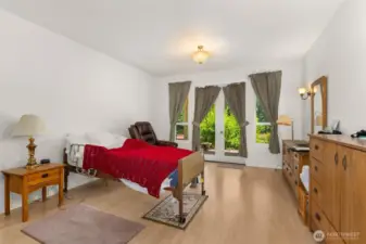 Primary bedroom with 2 walk-in closets, french doors and 5 piece on-suite.