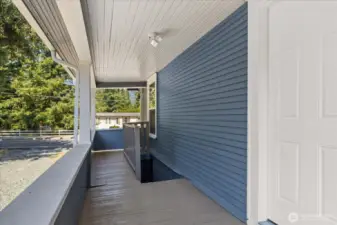 Covered back porch with stairs down to the unfinished basement.