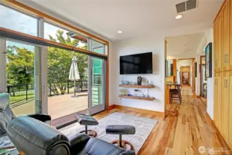 Family room with large TV and floating Shelves.