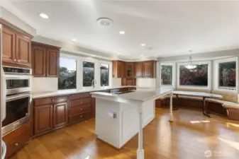 The heart of the home is a chef’s kitchen featuring quartz countertops, stainless steel appliances, center island, and a built-in breakfast nook. This space opens seamlessly to a large deck and a welcoming great room.