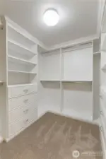 Walk-in closet with newly installed California Closet system.