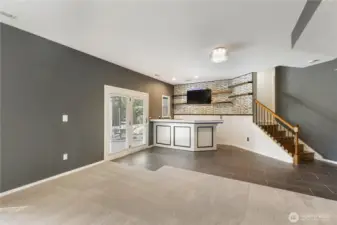 The bar area comes complete with beverage refrigerator, mounted TV and easy access to a covered patio.