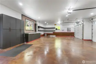 Oversized 3-car attached garage with storage cabinets, work area, access to additional attic storage and more!
