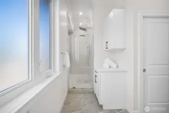 Dual head walk-in shower with towel storage.