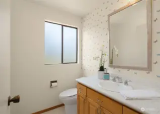 A convenient half bath is also on the main level, just off the kitchen.