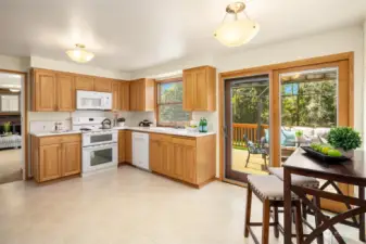 The large eat-in kitchen is light and bright with passage to every room on the main floor, as well as the large, west-facing deck easily accessed by the double-paned sliding door.