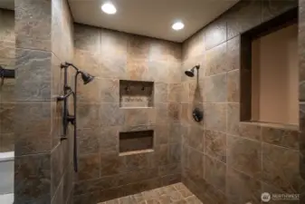 The walk-in shower in the master suite, with multiple shower heads.