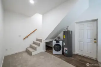 Laundry, storage and door to side porch at Hill House Garage/Shop. Up the stairs is an extra bedroom.