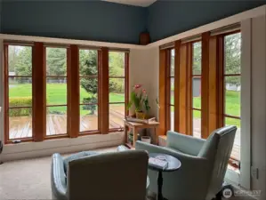 A corner of the living room, looking out onto the deck and grounds.