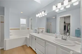The primary suite 5 piece bath includes a separate tub and shower, double sinks and plenty of counterspace.