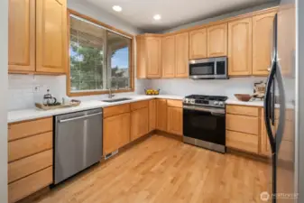 Newer counter top, Bosch dishwasher and stainless steel appliances.