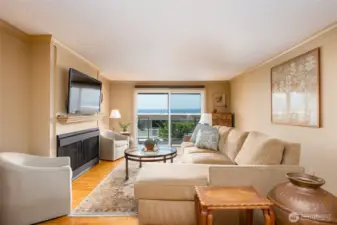 Sunny, welcoming living room with gas fireplace.