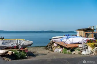 Boat launch, water toys are stored at the water's edge.