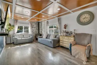 Cozy wood stove and large windows bring warmth and light.