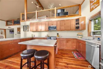 Open-concept kitchen offering a clear view of the loft above. Remote garage in far left upper cupboard. Fun!!!