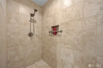 Master bathroom shower featuring custom tile work and premium hardware