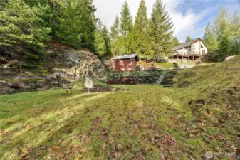 Lush, tiered landscaping that complements the natural beauty of the lot