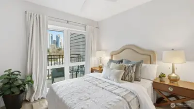 Primary suite with city views, walk-in closet and attached bath with frameless walk-in shower