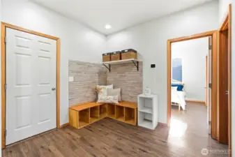 Just off the 2-car garage, the spacious mudroom keeps daily life organized. Built-in bench seating and storage provide a place for shoes, backpacks, and coats. The thoughtful layout helps minimize clutter in main living areas. It’s a practical feature that makes a big difference.