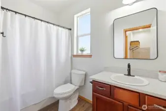 The downstairs full bath is ideal for guests or extended stays. Clean finishes and easy access make it highly functional. Its placement near the main-level bedroom adds versatility.