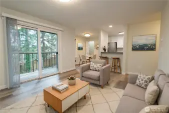 Virtually-staged living and dining areas to show the spaciousness and versalityKitchen features brand new cabinetry + stainless steel appliance suite (fridge, range, dishwasher and microwave). New quartz countertops. Eating bar area as well as a dining area.  Large storage closet for pantry, etc.  This home has so many amenities and upgrades.  New paint and Luxury vinyl plank flooring!  The large balcony is perfect to both start and end a day.....very private home that almost feels like you are in a park.