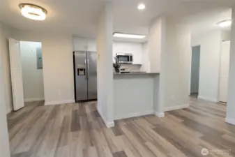 Kitchen features brand new cabinetry + stainless steel appliance suite (fridge, range, dishwasher and microwave). New quartz countertops. Eating bar area as well as a dining area.  Large storage closet for pantry, etc.  There are a LOT of storage closets in this home.  New paint and Luxury vinyl plank flooring throughout.  New carpetinhg in the bedrooms.