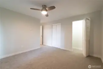 Non-staged view of the same primary bedroom.  Very large and private primary suite includes 2 closets and brand new paint and plush carpeting.  Bathroom just around the corner.