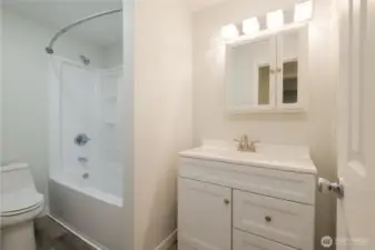 Bathroom 1 of 2.  Newly updated with cabinets and fixtures and flooring.