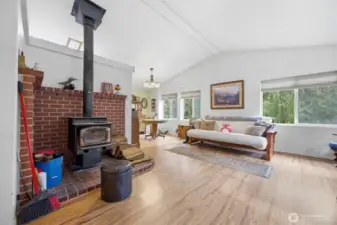 The wood stove heats this entire home and there is a ceiling fan in the kitchen to help circulate the warm air.