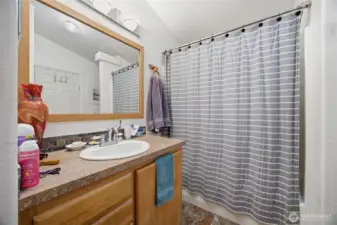 There is a full bath between the laundry room and one of the bedrooms.
