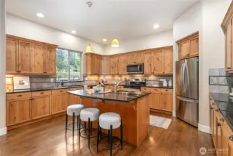 Large kitchen with tall ceilings and an island with sink