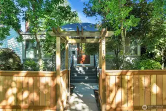 a lovely front arbor welcomes you to this gated and fully fenced front and back yard for maximum privacy and security for you and your pets!
