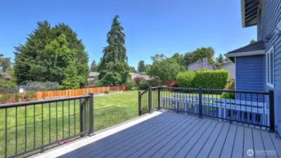 Trex deck leads to flat yard with fruit trees!