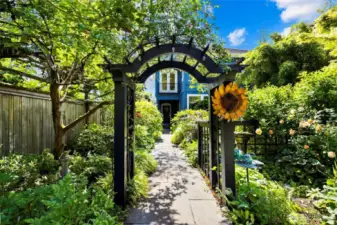 Enchanting gardens surround the home, with stone paths winding through the grounds fit for a master gardener.