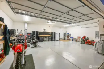 Oversized 3-car garage ready for all your vehicles and toys! Cabinets and shelves stay!